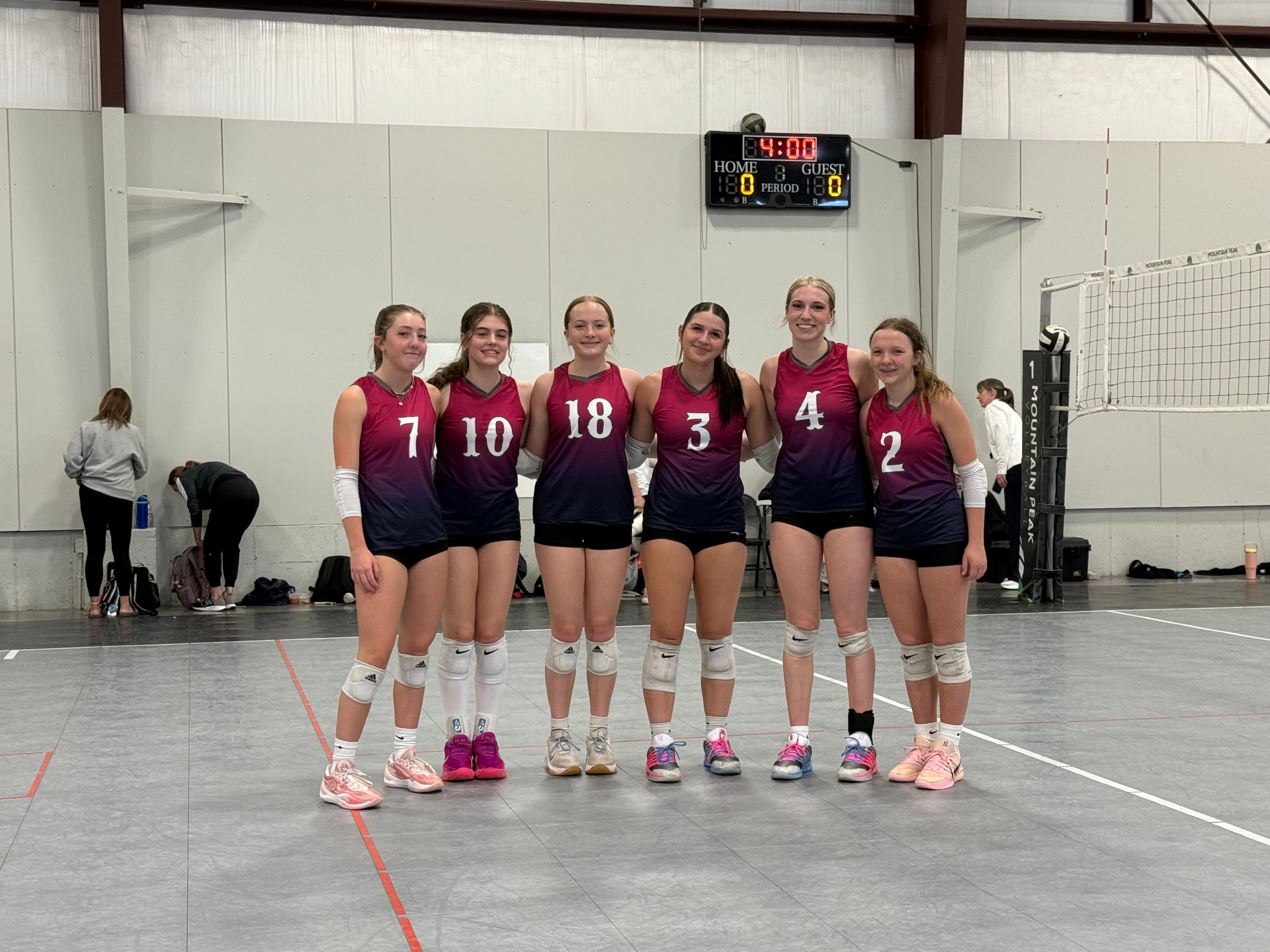 Zapata VBC players in maroon and navy jerseys on the court at a tournament